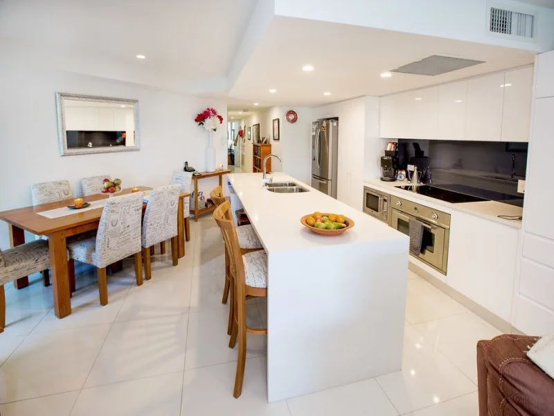White open-plan kitchen cabinetry in a Brisbane residence