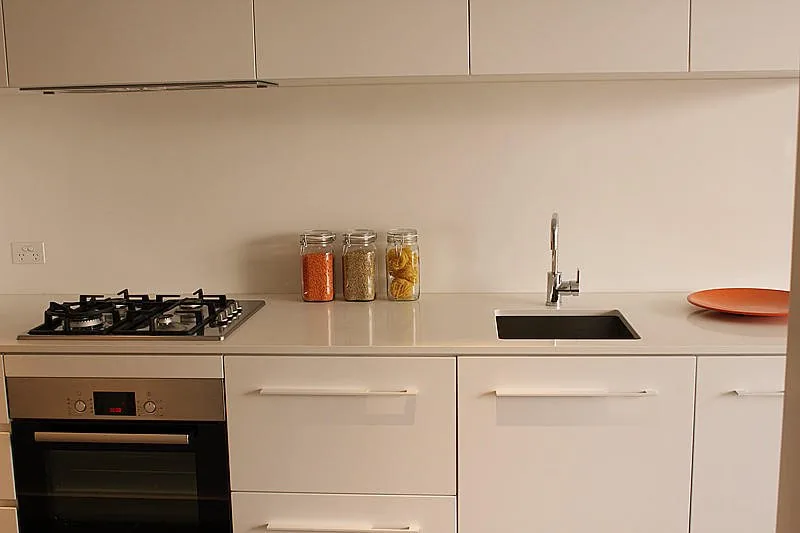 Minimal lacquer kitchen cabinetry in a Melbourne apartment