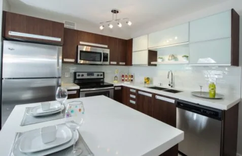 Dark timber-tone kitchen cabinetry in a Saskatoon townhouse