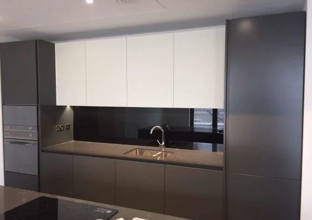 Dark custom kitchen cabinetry in a central London apartment