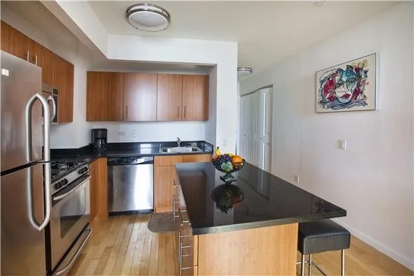 Warm wood kitchen cabinetry in a Manhattan apartment