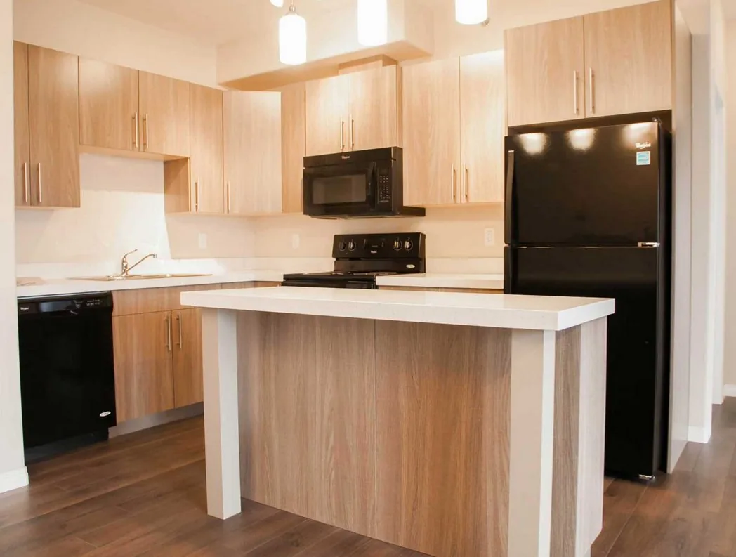 Timber-tone kitchen cabinetry in a Saskatoon mixed-use residence