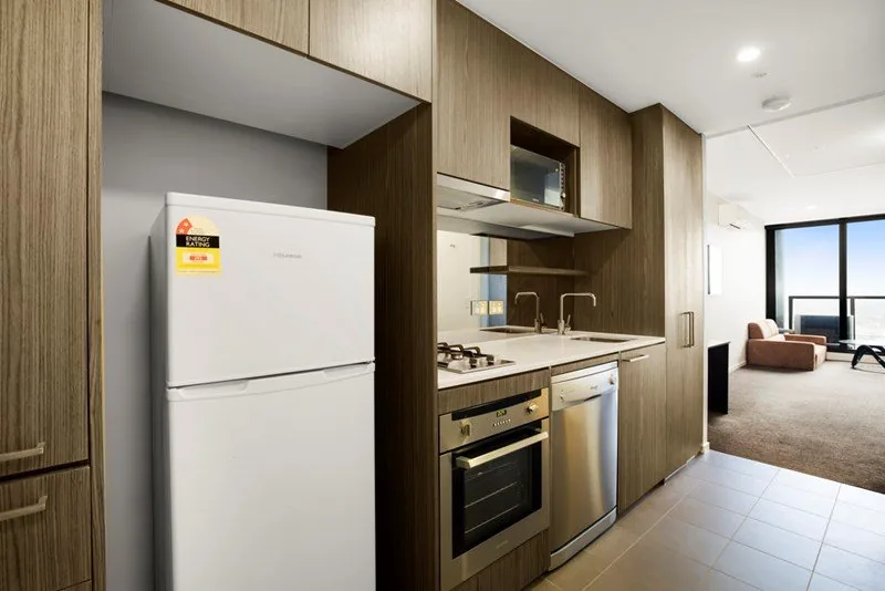 Timber and white kitchen cabinetry in a central Melbourne apartment