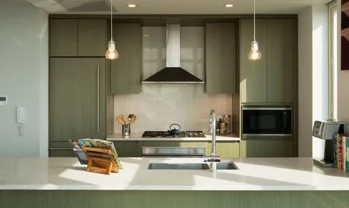 Grey and white kitchen cabinetry in a Brooklyn apartment